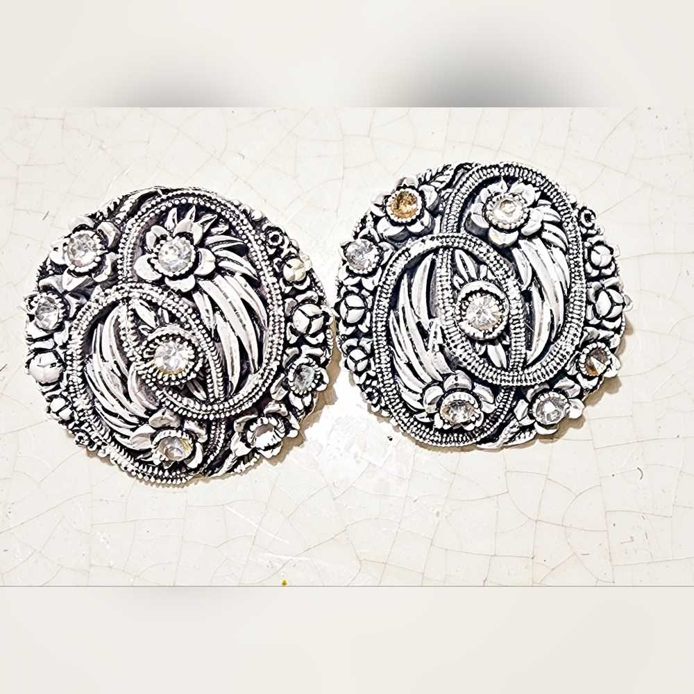 1960s intricate grey floral carved clip on earrings one missing a few rhinestone